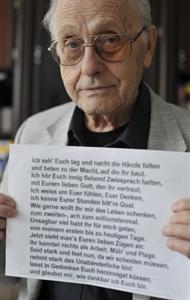 83-year-old Berliner Manfred Joachim, whose father was Jewish, holds up a poem written by his eldest brother\'s wife on March 4, 1943, the day she was hanged by the Nazis at Berlin\'s Ploetzensee prison for her work in the German resistance, in his Berlin flat July 17, 2008.