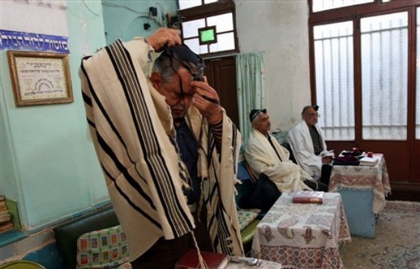 An Iranian Jewish man prepares for morning prayers during a ceremony in a synagogue in Isfahan, some 400 kms (240 miles) south of Tehran, Iran, on Thursday Oct. 25, 2007.
