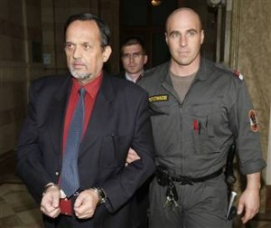 Gerd Honsik led away in handcuffs 