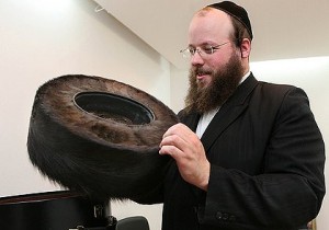 Australian-born shtreimel maker Moshe Weiner holds a hand-made fur hat at his Jerusalem workshop. Photo: Gali Tibbon