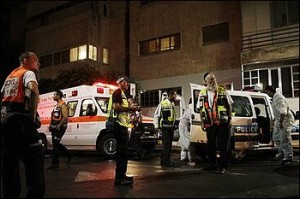 Israeli police officers and rescue work in a site of a shooting attack in Tel Aviv, Israel, Saturday, Aug. 1, 2009