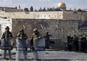 The Dome of the Rock is seen in the background as Israeli border police officers stand guard after clashes with Palestinian stone-throwers in the East Jerusalem neighbourhood of Ras al-Amud October 5, 2009.