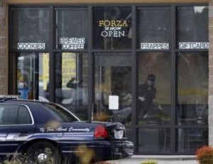 crime scene investigator from the Washington State Patrol looks over the scene where four police officer were shot and killed at a coffee shop in the Tacoma suburb of Parkland, Washington, November 29, 2009