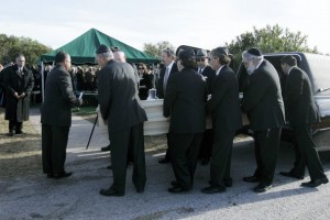  Pallbearers carry out the casket Tuesday during funeral services at Seaside Memorial Park. Hundreds of family, friends and employees turned out for the service. [Photo by Michael Zamora/Caller-Times].