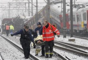 Emergency workers carry the victim of a train crash on a stretcher at the site of the crash near Halle February 15, 2010.