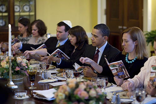 In this photo Obama is seen removing a drop when reciting each of the ten makos (plagues). The White House 2010 Seder. From right to left, Jen Psaki, deputy communications chief; President Obama, Lisa Kohnke, deputy director of White House advance, Eric Lesser, assistant to White House senior advisor David Axelrod; his mother, Joan Lesser, and Joanna Cohen, step-daughter of Susan Sher, chief of staff for First Lady Michelle Obama and White House liaison to the Jewish community.