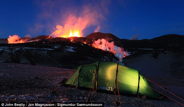  The lights inside the tent used by John Beatty and guide Jon Magnussen on the glacier are no match for the dramatic display from the smouldering volcano that is just half a mile away.
