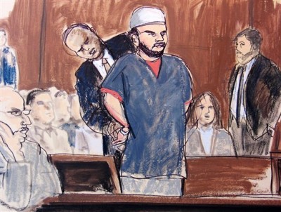 In this courtroom sketch, a U.S. Marshall removes Faisal Shahzad's handcuffs in the courtroom Monday, June 21, 2010, in New York. Shahzad, who appeared in federal court on an indictment accusing him of plotting a failed Times Square car bombing, was told by a judge that his hearing is being postponed until later Monday afternoon. He's accused in a plot that fizzled when a gasoline-and-propane bomb failed to ignite in a sport utility vehicle parked near a Broadway theater May 1. (AP Photo/Elizabeth Williams)