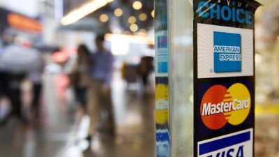 The average combined debt for bank-issued credit cards — like those with a MasterCard or Visa logo — fell to $4,951 in the three months ended June 30.