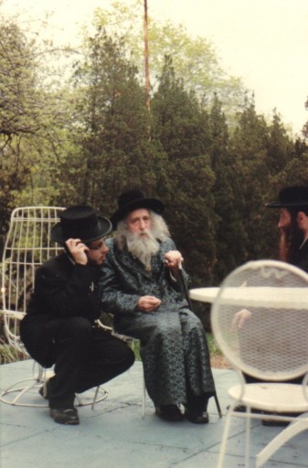 FILE - Photo taken in Monsey NY, in rebbes backyard 1982, on right side with black beard sitting the mashba'k r' Moshe Berkowitz & on the left with brown beard is mashba'k r' Avrom Hersh Glick