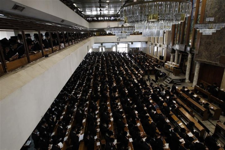 Ultra-Orthodox Jewish men take part in a burial ceremony in Bnei Brak near Tel Aviv for Torah scrolls that were destroyed in a fire, October 7, 2010. Eleven torah scrolls were damaged in a fire that broke out in a synagogue during the Jewish holiday of Sukkot following a short circuit in the Holy Ark. REUTERS/Ronen Zvulun 