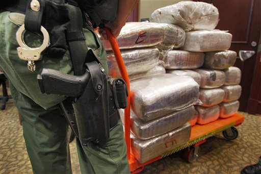 Law enforcement wheels out marijuana stacked in bales during a news conference at the Clayton County Justice Center in Jonesboro, Ga., Thursday, Nov 4, 2010.
