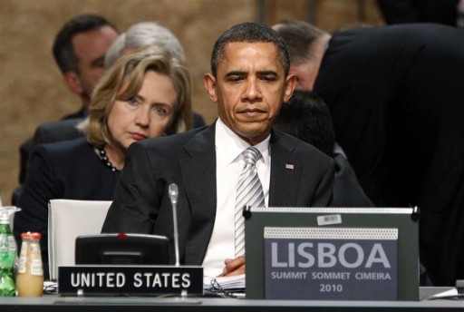 U.S. President Barack Obama attends the opening session of the meeting on Afghanistan at the NATO Summit in Lisbon November 20, 2010. Seated behind is U.S. Secretary of State Hillary Clinton. REUTERS/Kevin Lamarque