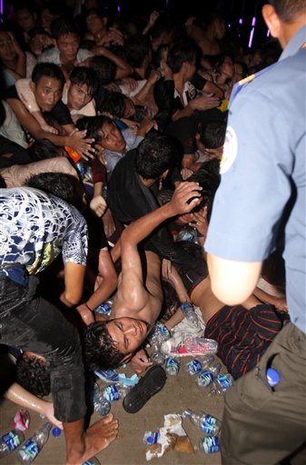 An injured Cambodian seeks help after a stampede onto a bridge during the last day of celebrations of the water festival in Phnom Penh, Cambodia, Monday, Nov. 22, 2010. Thousands of people celebrating a water festival on a small island in a Cambodian river stampeded Monday evening, killing many people, a hospital official said. Hundreds more were hurt as the crowd panicked and pushed over the bridge to the mainland. (AP Photo/Heng Sinith)