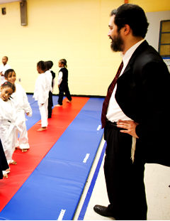 Principal Shimon Waronker (r.) observes students taking an after school karate class within the New American Academy school in Crown Heights, Brooklyn on November 10, 2010.