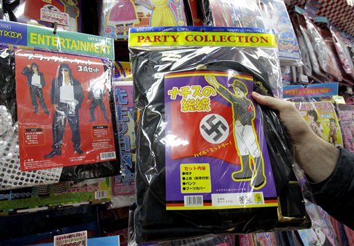 A Nazi costume, which includes a black jacket with a swastika armband and a sketch resembling Adolf Hitler on the package, with the phrase "Heil Hitler" is displayed for sale at retailer Don Quijote Co., in Tokyo, Tuesday, Dec. 7, 2010. The Japanese discount chain said Tuesday that it will pull the costume from its shelves after a complaint from a Jewish organization in the U.S. (AP Photo/Koji Sasahara)