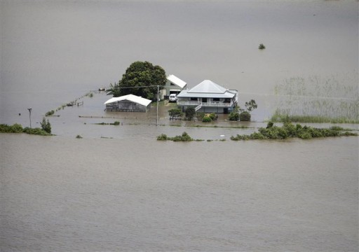 A house is surrounded by flood waters near the town of Lawrence about 225km (140 miles) south of Brisbane January 12, 2011. REUTERS/Wolter Peeters