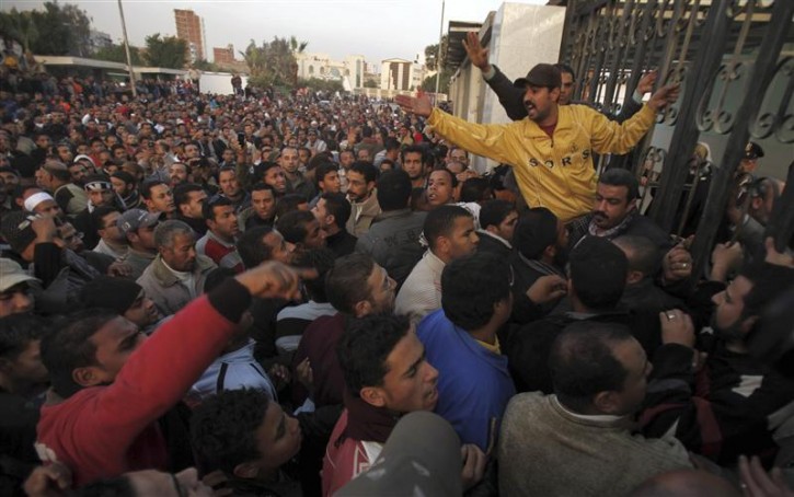 People, including relatives of Gharib Abdelaziz Abdellatif, attempt to enter the hospital grounds to retrieve his body in the port city in Suez, about 134 km (83 miles) east of Cairo, January 26, 2011. Gharib, 45, died of internal bleeding after police shot him in the stomach on Wednesday, according to medical sources. Police fought with thousands of Egyptians who defied a government ban on Wednesday to protest against President Hosni Mubarak's 30-year-old rule, firing rubber bullets and tear gas and dragging away demonstrators. REUTERS/Mohamed Abd El-Ghany  (EGYPT - Tags: CIVIL UNREST POLITICS IMAGES OF THE DAY)