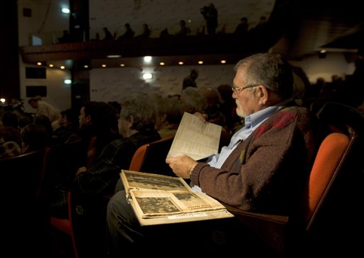 A man reads from a booklet of newspaper cuttings during a discussion marking 50 years since Nazi SS officer Adolf Eichmann's trial in Jerusalem, on the U.N.'s annual Holocaust Remembrance Day, Thursday, Jan. 27,  2011. Fifty years after Nazi criminal Adolf Eichmann was brought to justice, the men who captured and prosecuted the Holocaust mastermind held a rare reunion Thursday in the Jerusalem hall where his famous trial took place.(AP Photo/Sebastian Scheiner)