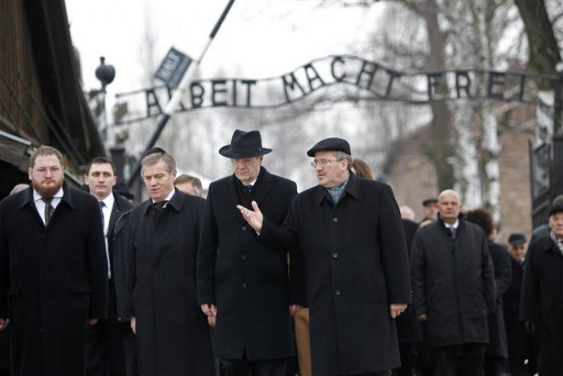 Polish President Bronislaw Komorowski (R) gestures to German President Christian Wulff after passing through the gate, with the words "Arbeit macht frei" (Work sets you free), of the former Nazi death camp of Auschwitz during ceremonies marking the 66th anniversary of the liberation of this camp by Soviet troops and to remember the victims of the Holocaust in Auschwitz January 27, 2011.   REUTERS/Kacper Pempel 