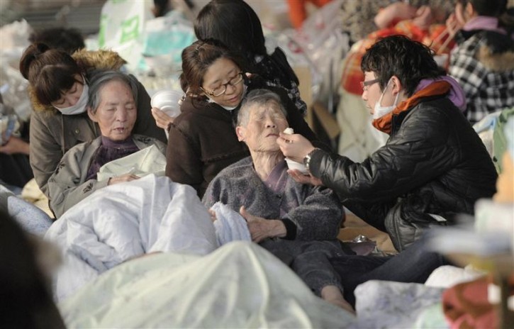 An elderly person has a meal at an evacuation centre in Kesennuma City, Miyagi Prefecture in northern Japan, after an earthquake and tsunami struck the area, March 13, 2011. Japan faces a growing humanitarian crisis on a scale not seen since World War Two after its devastating earthquake and tsunami left millions of people without water, electricity, homes or heat.   REUTERS/Kyodo
