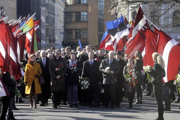 Members of Latvia's Parliament Dzintars Rasnacs (3-L), Raivis Dzintars (C) and other participants during parade close to Freedom Monument in Riga, 16 March 2011 to commemorate those who fought in two German Waffen-SS divisions in World War II.  EPA/STRINGER LATVIA 