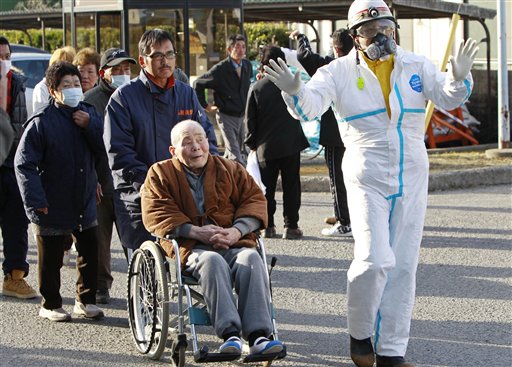 An elderly man taken by wheelchair to be scanned for levels of radiation in Koriyama, Fukushima Prefecture, Japan, Sunday, March 13, 2011. Friday's quake and tsunami damaged two nuclear reactors at a power plant in the prefecture, and at least one of them appeared to be going through a partial meltdown, raising fears of a radiation leak. (AP Photo/Mark Baker)