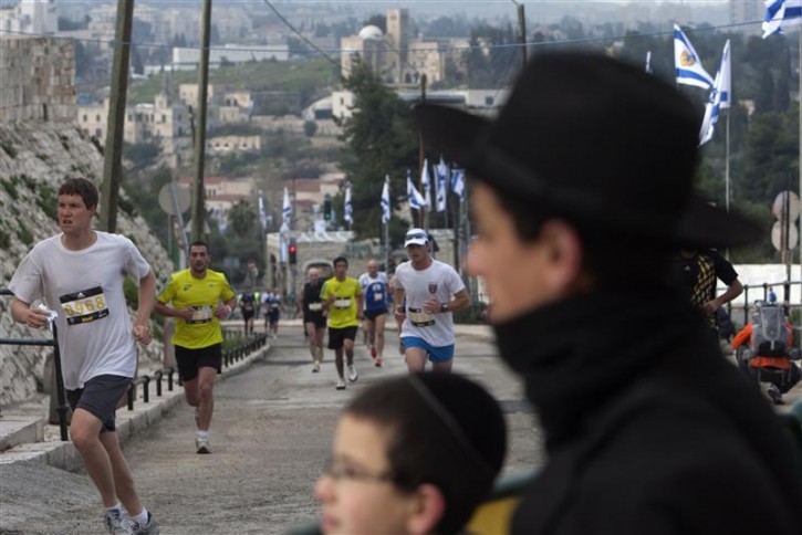 Runners enter Jerusalem's Old City, near Jaffa Gate, during the first international Jerusalem Marathon March 25, 2011. The event is the first ever full marathon that the city has hosted. REUTERS/Ronen Zvulun 