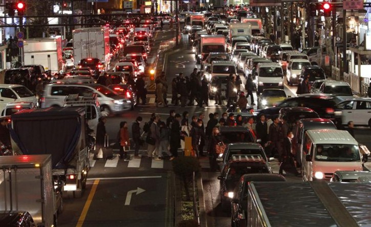 Traffic is in chaos as people are forced to walk home between grid locked vehicles in central Tokyo after an earthquake  March 11, 2011. The biggest earthquake to hit  Japan on record struck the northeast coast on Friday, triggering a 10-metre tsunami that swept away everything in its path, including houses, ships, cars and farm buildings on fire.  REUTERS/Toru Hanai 