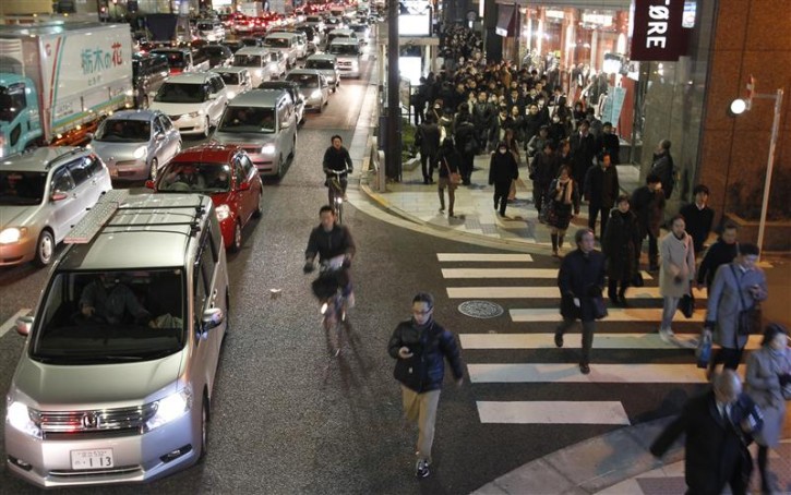 Residents walk between grid locked vehicles on their way home among chaotic traffic in central Tokyo, after an earthquake off the coast of northern Japan March 11, 2011. A massive 8.9 magnitude quake hit northeast Japan on Friday, causing many injuries, fires and a ten-metre (33-ft) tsunami along parts of the country's coastline. A tsunami warning has been issued for the entire Pacific basin except for the mainland United States and Canada following a huge earthquake that hit Japan on Friday, the Pacific Tsunami Warning Center said.  REUTERS/Toru Hanai 