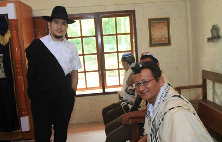 Yaakov Baruch (stading) in his Shul with community members Jan. 2011