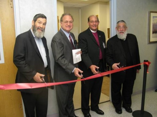 The ribbon is cut by Rabbi Elozer Kanner; hospital CEO Nelson Toebbe; Rt. Rev. Lawerence C. Provenzano of Episcopal Health System; and Rabbi Tzvi Flaum. 