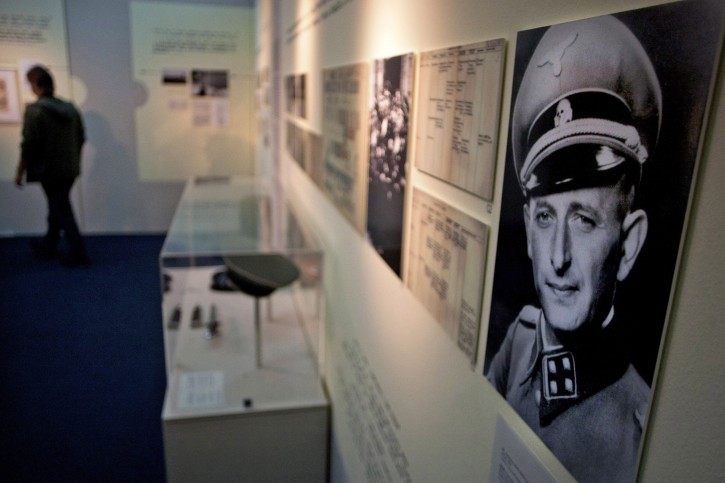 In this photo taken on Sunday, April 10, 2011, a visitor looks at an exhibition marking the 50th anniversary of Adolf Eichmann's trial in Jerusalem. Fifty years after the historic trial of Nazi criminal Adolf Eichmann began, Israel on Monday, April 11, 2011, marked the event that ushered in a new era of openness toward the Holocaust and its survivors with an exhibition that highlights the man and his murderous legacy.(AP Photo/Sebastian Scheiner)