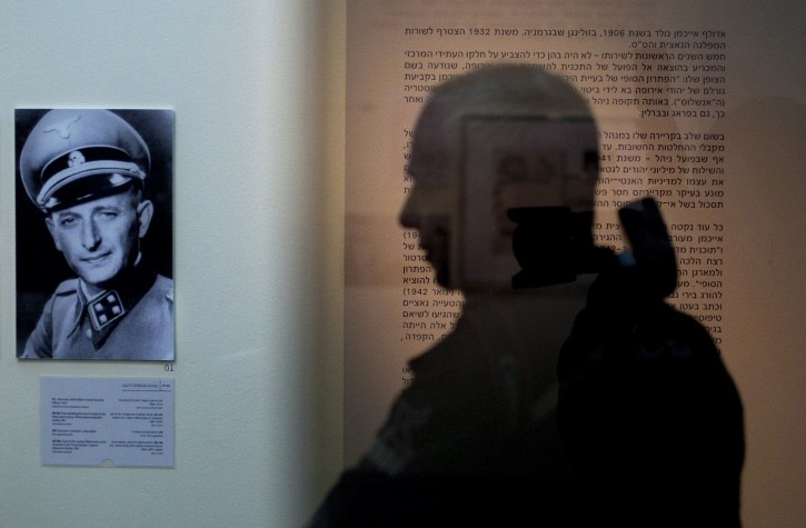 In this photo taken on Sunday, April 10, 2011, a visitor looks at an exhibition marking the 50th anniversary of Adolf Eichmann's trial in Jerusalem. Fifty years after the historic trial of Nazi criminal Adolf Eichmann began, Israel on Monday, April 11, 2011, marked the event that ushered in a new era of openness toward the Holocaust and its survivors with an exhibition that highlights the man and his murderous legacy. (AP Photo/Sebastian Scheiner)