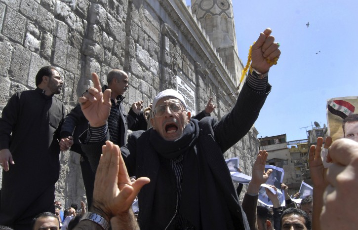 A Syrian pro-government protester shouts slogans during a protest following Friday prayers outside the Omayyad Mosque in Damascus, Syria, Friday, April 15, 2011. Calling for reforms, thousands of people demonstrated Friday in several Syrian cities amid little presence of security forces, activists and witnesses said. In central Damascus, hundred of regime supporters marched near the historic Umayyad mosque, carrying pictures of Assad and chanting "Our souls, our blood we sacrifice for you Bashar" as tens of thousands of people chanting "Freedom!" held protests in several Syrian cities Friday demanding far greater reforms than the limited concessions offered by President Bashar Assad. (AP Photo/Muzaffar Salman)