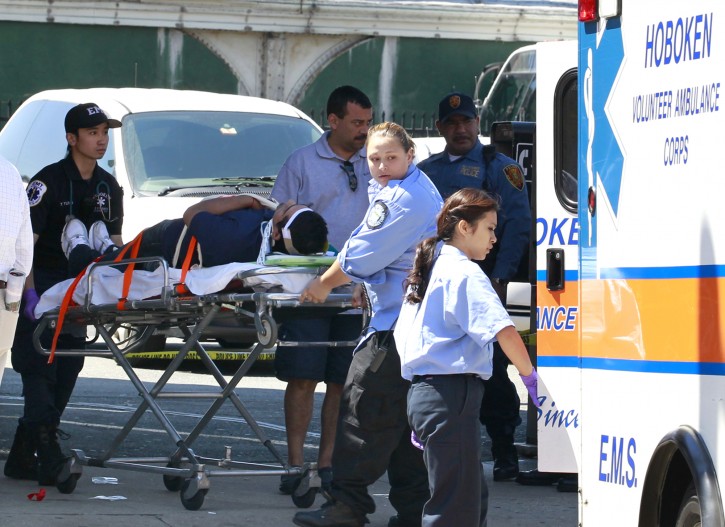 An unidentified man, who was injured during a PATH train crash at the Hoboken Terminal, is seen on a stretcher as medical officials prepared to take him to the hospital, Sunday, May 8, 2011, in Hoboken, N.J. A spokesman says a train pulling into the station struck an abutment, causing minor injuries. (AP Photo/Julio Cortez)
