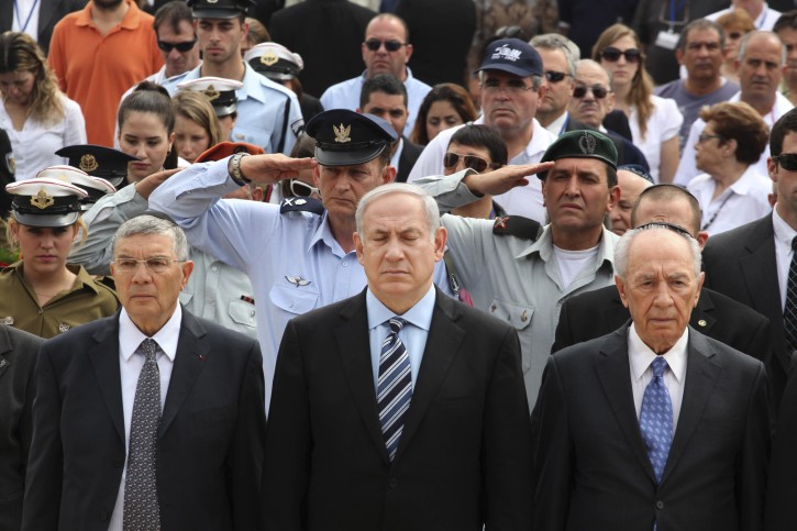 From left: Chairman of Yad Vashem Avner Shalev, Israeli Prime Minister Benjamin Netanyahu, and President Shimon Peres, observe two minutes of silence as sirens wail across Israel to mark Holocaust Remembrance Day during the annual ceremony at the Yad Vashem memorial in Jerusalem, Monday, May 2, 2011. The state of Israel marks the annual Memorial Day commemorating the six million Jews murdered by the Nazis in the Holocaust during World War II. (AP Photo/Gali Tibbon, Pool)