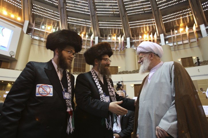 Wearing Palestinian scarves, anti-Zionist rabbis, Yisroel Dovid Weiss, center, from U.S., and Yeshaye Rosenberg, left, from Canada, greet Iranian Ayatollah Mohammad Ali Taskhiri, during the "International Conference on Global Alliance against Terrorism for a Just Peace" in Tehran, Iran, Saturday, May 14, 2011. (AP Photo/Vahid Salemi)