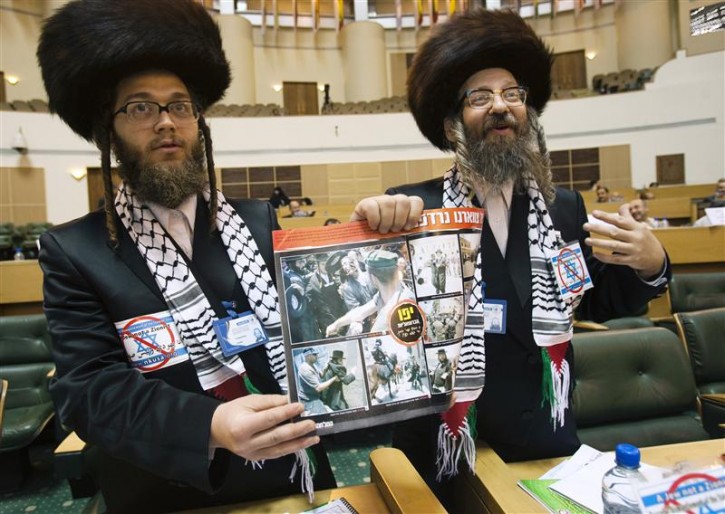 Reuters and other foreign media are subject to Iranian restrictions on leaving the office to report, film or take pictures in Tehran.  U.S. Rabbi Yisroel Dovid Weiss, of the organisation Jews United Against Zionism and Canadian Rabbi Yeshaye Rosenberg display a poster from an anti-Israeli campaign to journalists at International conference on Global Alliance against Terrorism for a Just Peace, in Tehran May 14, 2011. REUTERS/Raheb Homavandi