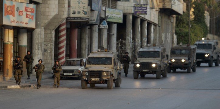 Israeli soldiers and vehicles patrol a street after a group of Jewish worshippers prayed at Joseph's Tomb in the West Bank city of Nablus early Monday, May 30, 2011. Secured by Israeli troops, hundreds of worshippers prayed at the tomb early Monday, just over a month since a Jewish man was killed by Palestinian police on his way to the site.(AP Photo/Nasser Ishtayeh)
