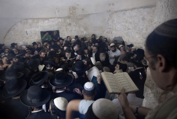 Ultra-Orthodox Jewish men pray at Joseph's Tomb in the West Bank city of Nablus, early Monday, May 30, 2011. Secured by Israeli troops, hundreds of worshippers prayed at the tomb early Monday, just over a month since a Jewish man was killed by Palestinian police on his way to the site.(AP Photo/Sebastian Scheiner)