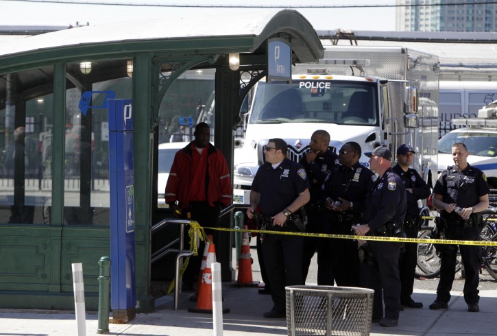 Emergency personnel gather near the entrance to the PATH station in Hoboken, Sunday, May 8, 2011. A spokesman says a train pulling into the station struck an abutment, causing minor injuries. (AP Photo/Seth Wenig)