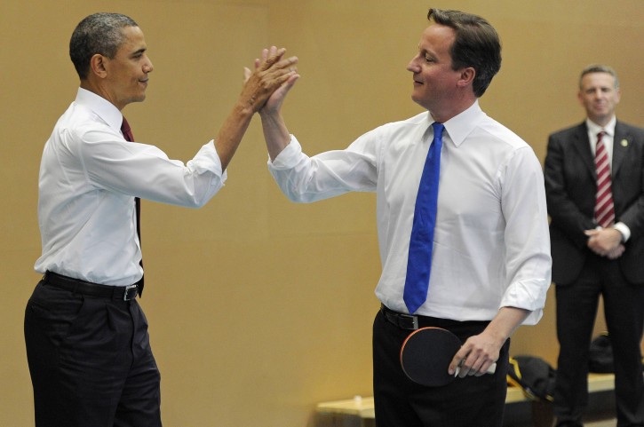 U.S. President Barack Obama, left,  and Britain's Prime Minister David Cameron  high-five as they play table tennis at Globe Academy, in south London  Tuesday May 24, 2011. President Barack Obama and first lady Michelle Obama traded-in Irish charm for the pomp and pageantry of Buckingham Palace Tuesday as they-day opened a  state visit to Britain at the invitation of Queen Elizabeth II. (AP Photo/Paul Hackett, Pool)