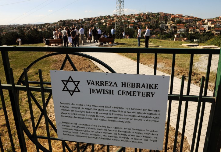 Students of the Dartmouth College in New Hampshire joined by students of the American University in Kosovo (AUK) participate in a dedication ceremony in the Jewish Cemetery in the capital Pristina on Thursday, June 23, 2011. AP