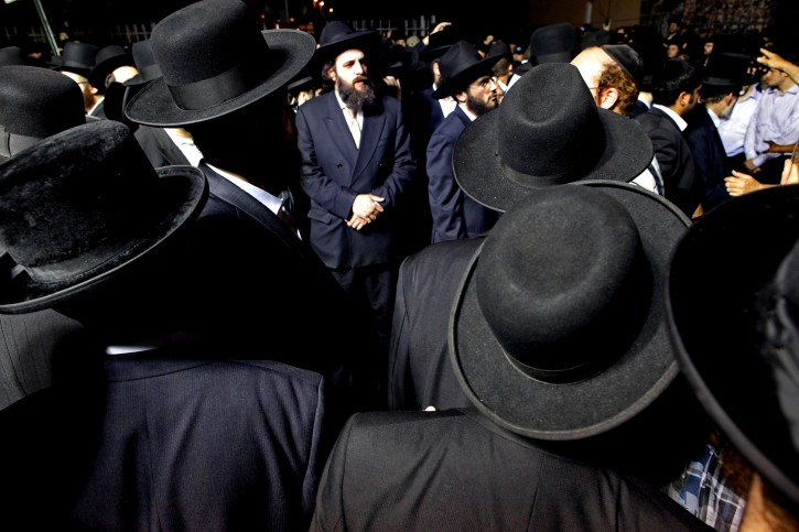 Community members and others wait before the start of a funeral service for Leiby Kletzky, 8, Wednesday, July 13, 2011 in the Brooklyn borough of New York. The Brooklyn boy, who got lost while walking home alone from day camp in his Orthodox Jewish neighborhood, was killed and dismembered by a stranger he had asked for directions, and his remains were found stuffed in a trash bin and the man's refrigerator, police said Wednesday. (AP Photo/Craig Ruttle)