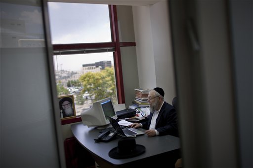 In this photo taken Monday, June 27, 2011, Rabbi Moshe Grylak, Editor-in-Chief of the weekly newspaper "Mishpacha" works in his office in Jerusalem. The community of ultra-Orthodox Jews in Israel, long an insular island where rabbis ruled and the outside world was viewed with suspicion or ignored altogether, is being quietly and profoundly altered by a proliferation of new media outlets shining a light on topics that were long taboo. (AP Photo/Bernat Armangue)