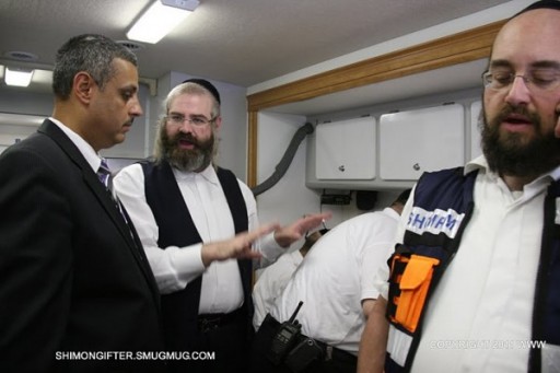 Simcah Bernath Shomrim coordinator, inside the command post speaking to an official. Reichberg head of Shomrim on the telephone
