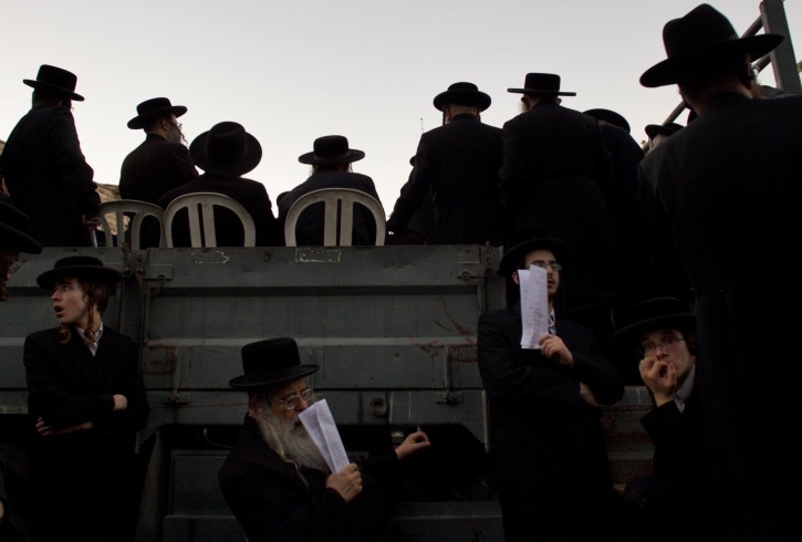 Ultra-Orthodox Jews attend a prayer as they gather in the religious neighborhood of Mea Shearim to protest against summer events organized by the city council, Jerusalem, Thursday, Aug. 11, 2011. (AP Photo/Bernat Armangue)