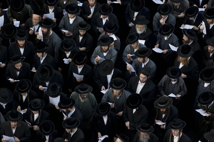 Ultra-Orthodox Jews attend a prayer as they gather in the religious neighborhood of Mea Shearim to protest against summer events organized by the city council, Jerusalem, Thursday, Aug. 11, 2011. (AP Photo/Bernat Armangue)
