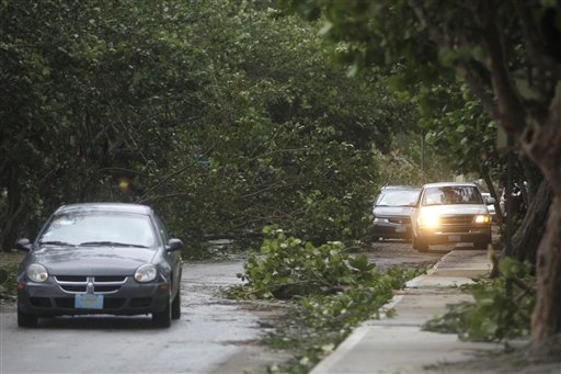 Cars wind their way around downed trees on the coastal road in the aftermath of Hurricane Irene in Nassau, on New Providence Island in the Bahamas, Thursday, Aug. 25, 2011. Irene hit Nassau with tropical storm strength winds as it passed to the east.  (AP Photo/Lynne Sladky)